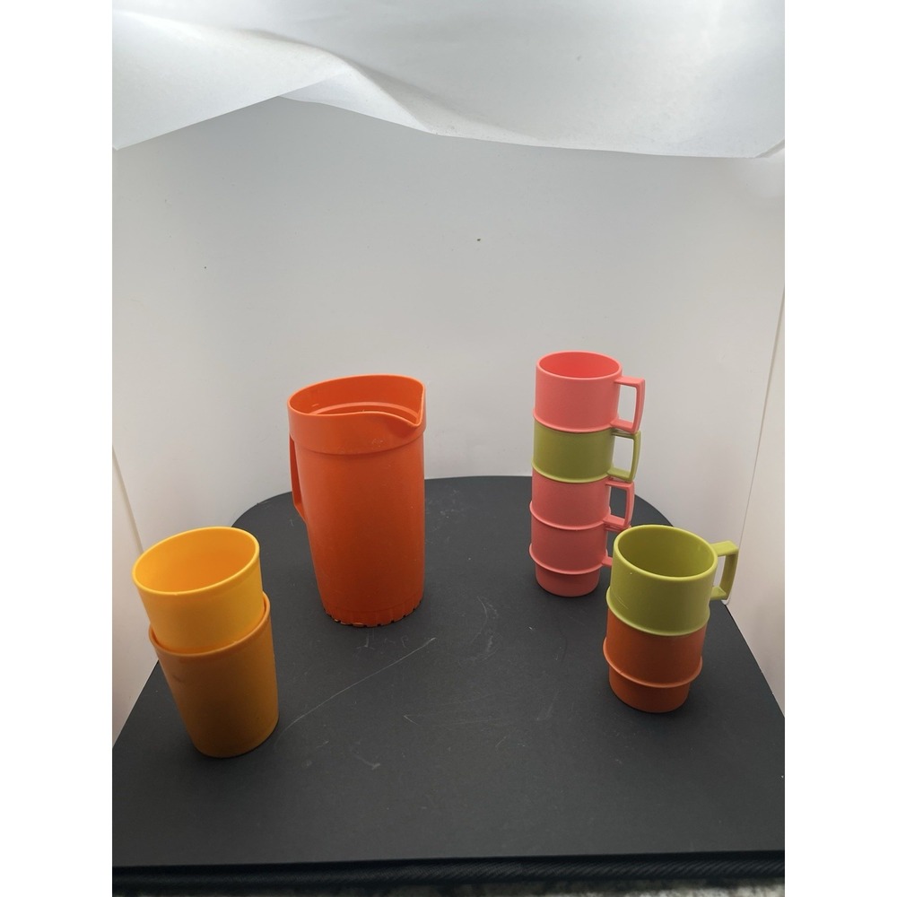 vintage Tupperware stacking mugs and a pitcher